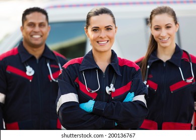 Beautiful Young EMT And Colleagues In Front Of Ambulance