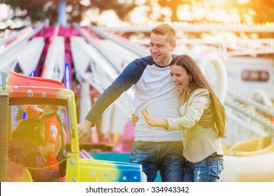 Beautiful Young Family Enjoying Their Time At Fun Fair