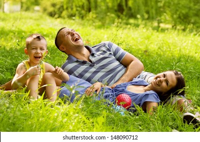 Beautiful Young Family Having Fun Outdoors