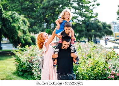 Beautiful Young Family With Ice Cream Walking On The Street