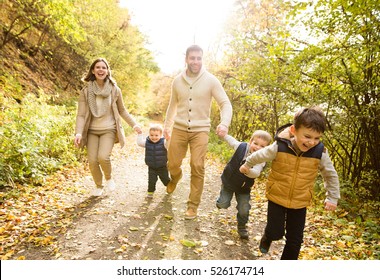 Beautiful young family on a walk in autumn forest. - Powered by Shutterstock