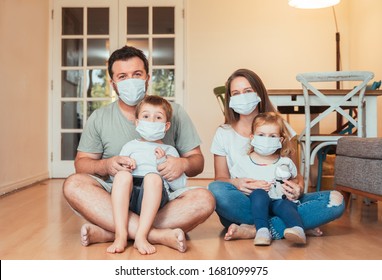 Beautiful Young Family Wearing Face Masks Against Coronavirus World Pandemic And Staying Home