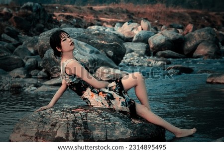 Similar – beautiful brunette short hair girl leaning on gray rock wall outdoors smiling happy