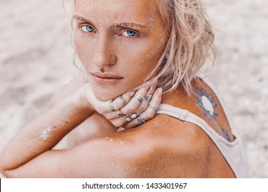 beautiful young fashion model on the beach. Close up portrait of boho model 