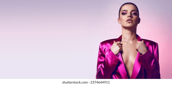 Beautiful young fashionable woman in a pink neon jacket and evening makeup. Fashionable woman, evening clothing style. Bright evening makeup, healthy tanned skin.