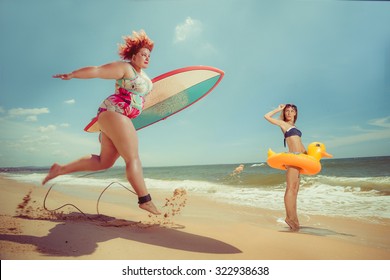 Beautiful young fat woman is runing to the summer sea with the surfboard 