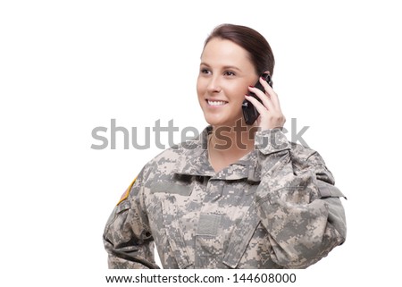 Beautiful young female American soldier talking over cellphone 