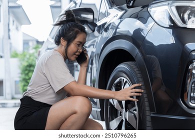 Beautiful young female bicycle mechanic talking to a customer using phone. Woman Inflating Car Tyre With Electric Pump On Country Road, maintenance and safety transportation concept. - Powered by Shutterstock