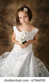 Beautiful Young Female Child Wearing Her Mother's Wedding Dress Which Is Too Big For Her