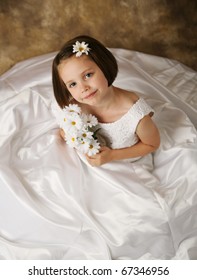 Beautiful Young Female Child Wearing Her Mother's Wedding Dress Which Is Too Big For Her