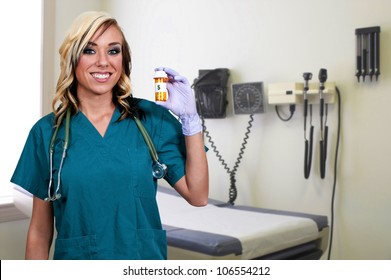 A beautiful young female doctor on her rounds holding a prescription bottle of medicine pills