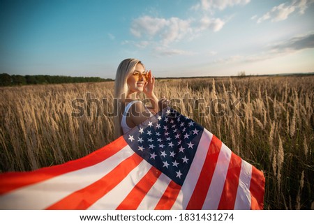 beautiful young female in sunglasses with american flag