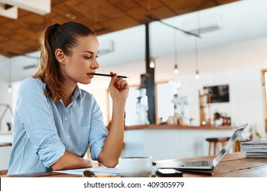 Beautiful Young Freelancer Woman Using Laptop Computer Sitting At Cafe Table. Happy Smiling Girl Working Online Or Studying And Learning While Using Notebook. Freelance Work, Business People Concept   - Shutterstock ID 409305979
