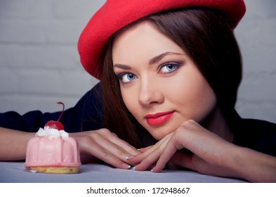 Beautiful Young French Woman With Pink Cake On Top Of Which Cherry