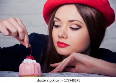 Beautiful Young French Woman With Pink Cake On Top Of Which Cherry