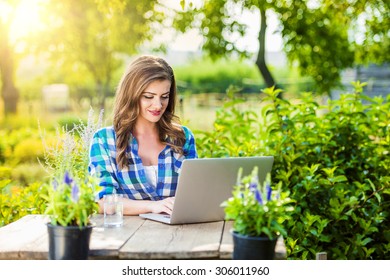 Beautiful young garden manager with notebook working outside - Shutterstock ID 306011960