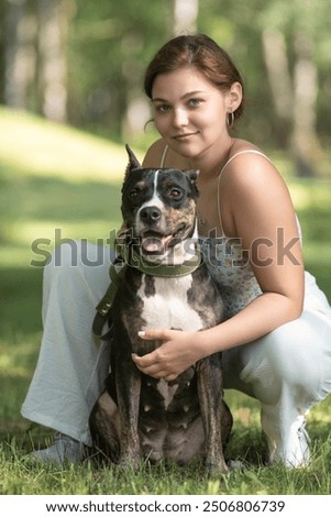 Similar – Pretty blond woman with her two dogs