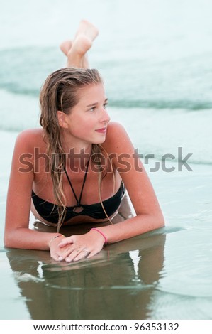 Beautiful young girl in bikini at the beach