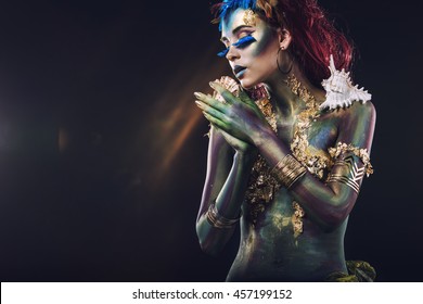 Beautiful young girl with body art in an unusual fantasy style