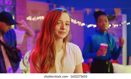 Beautiful young girl with charming smile looking at camera staying with best friends celebrating disco party reunion together. Communication and friendship concept. - Shutterstock ID 1632273655