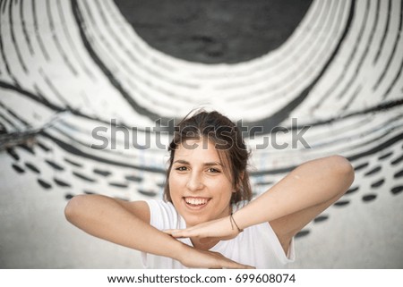 Image, Stock Photo Smiling brunette girl holding surfboard over her head