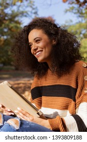 Beautiful Young Girl With Dark Curly Hair Using Tablet Computer, Outdoor.