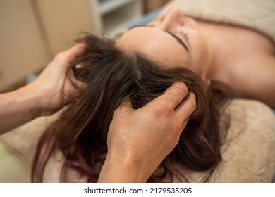 Beautiful Young Girl With Dark Hair Doing A Head Massage In A Massage Parlor. Head Massage Concept