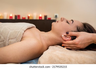 Beautiful Young Girl With Dark Hair Doing A Head Massage In A Massage Parlor. Head Massage Concept