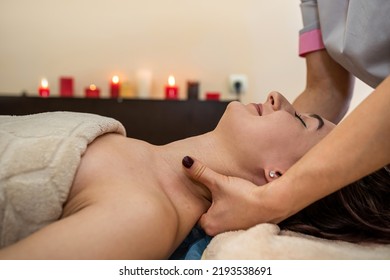 Beautiful Young Girl With Dark Hair Doing A Head Massage In A Massage Parlor. Head Massage Concept