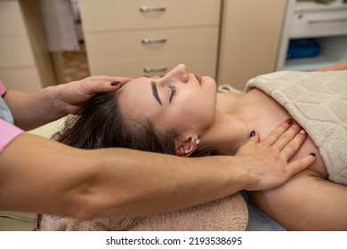 Beautiful Young Girl With Dark Hair Doing A Head Massage In A Massage Parlor. Head Massage Concept