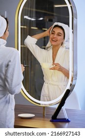 Beautiful Young Girl Doing Makeup In Front Of A Mirror. Bride's Morning Concept. Beauty Salon