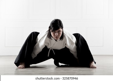 beautiful young girl dressed in a hakama doing aikido