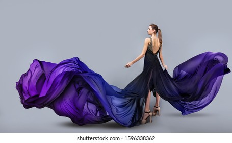 beautiful young girl in flying dress  Flowing fabric  Light transparent fabric flutters in the wind  Multicolored material is painted and beautiful gradient