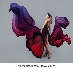 beautiful young girl in flying dress  Flowing fabric in the shape butterfly wings  The light fabric flutters in the wind  Multi  colored gradient staining thin material
