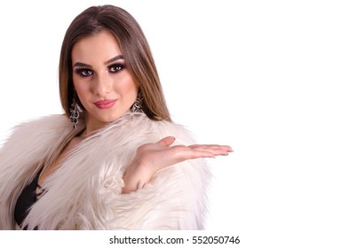 Beautiful young girl holding an empty hand outstretched. Add the product or text on the empty space of the palm - Shutterstock ID 552050746