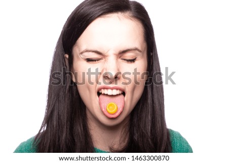 beautiful young girl holding in her mouth a lollipop against cough