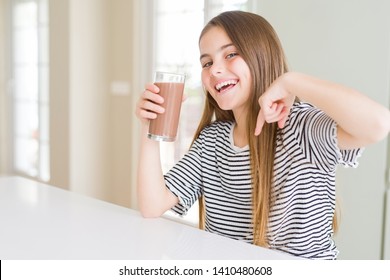 Beautiful Young Girl Kid Drinking Fresh Tasty Chocolate Milkshake As Snack With Surprise Face Pointing Finger To Himself