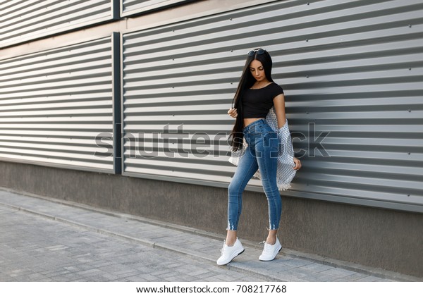 black shirt blue jeans white shoes