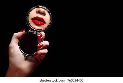A beautiful young girl looks in the mirror and sees a reflection of red lips.Beauty, fashion, hairstyle, stylist, boutique, advertising, discounts, beauty salon, magazine.