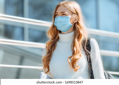 Beautiful Young Girl In A Mask From Coronovirus, Student On The Background Of Educational Envy, Women Returning From Work, Remote Work, Covid-19