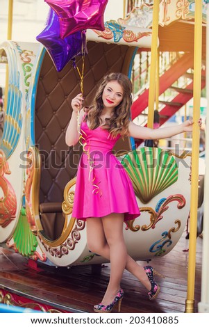 Beautiful young girl on a merry go round