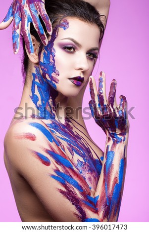 and beautiful young girl with paint on body and hands