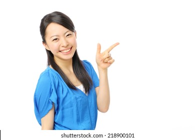 beautiful young girl pointing copy space - Shutterstock ID 218900101