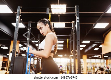 Beautiful Young Girl Professional Triathlete Is Preparing For A Competition And Is Known In The Gym. The Concept Of A Healthy Lifestyle And Professional Sports Career