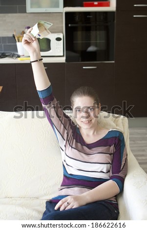 Similar – Happy girl using a smart phone sitting on a couch at home