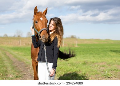 Beautiful young girl smile at her horse dressing uniform competition: outdoors portrait on sunny day