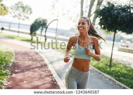 Similar – Fit healthy athletic woman jogging on a river bank