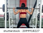 beautiful young girl in sportswear doing exercise in the gym. Training concept in the gym