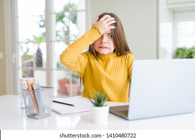 Beautiful Young Girl Studying For School Using Computer Laptop Stressed With Hand On Head, Shocked With Shame And Surprise Face, Angry And Frustrated. Fear And Upset For Mistake.