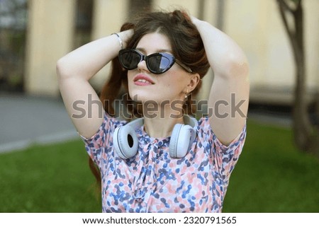 Similar – Young redhead woman listening to music